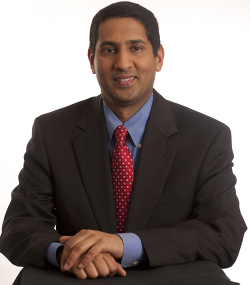 Arun Murthy wearing a suit and red tie.