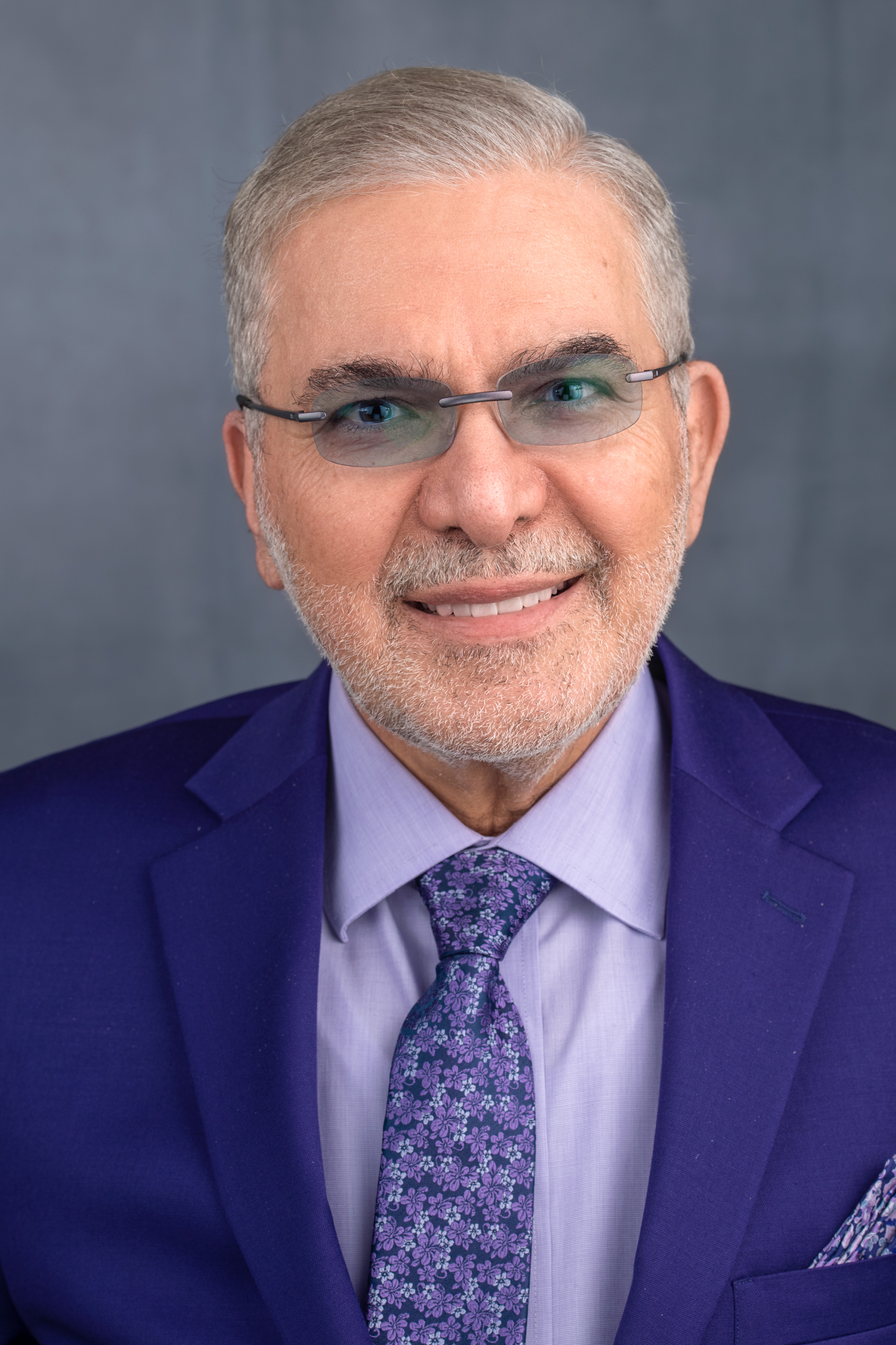 Headshot of Henry Nasrallah wearing a suit.